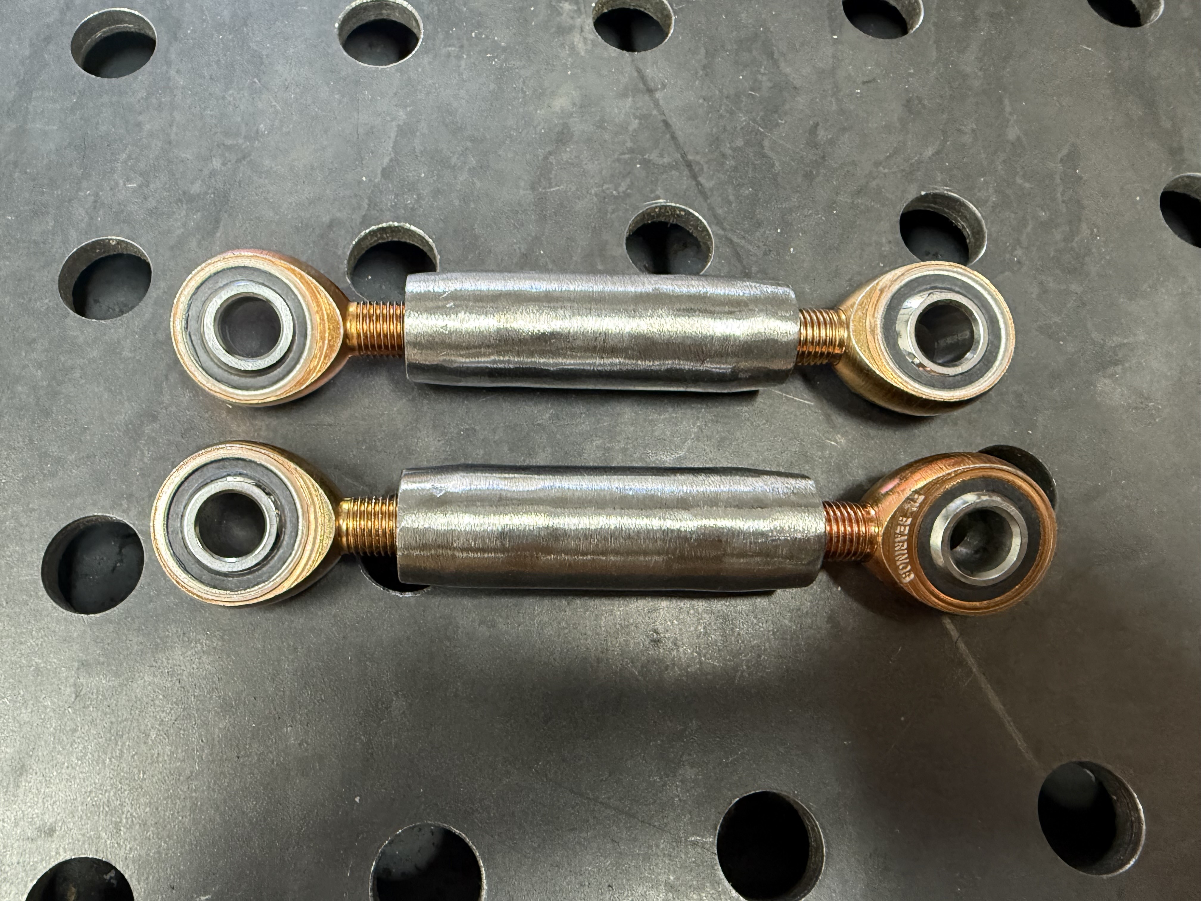 Custom tie rods connecting the rack and pinion to the upright